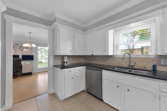 7403 Theisswood Rd, Spring, TX 77379 - kitchen with stainless steel dishwasher, dark countertops, white cabinets, crown molding, and decorative backsplash