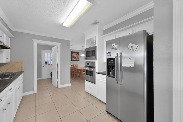 7403 Theisswood Rd, Spring, TX 77379 - kitchen featuring appliances with stainless steel finishes, dark countertops, white cabinets, ornamental molding, and light tile patterned floors