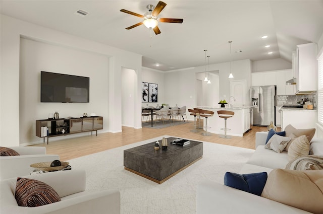 8426 Kari Bend Cir, Richmond, TX 77407 - living room with light wood-style floors, ceiling fan, and recessed lighting
