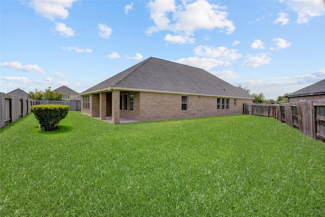 8426 Kari Bend Cir, Richmond, TX 77407 - rear view of house with brick siding, a fenced backyard, a patio, and roof with shingles