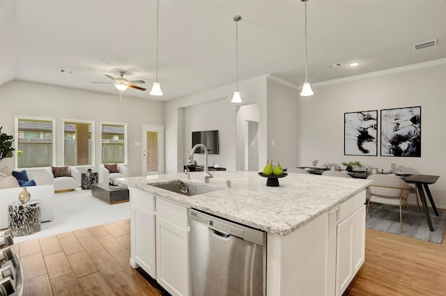 8426 Kari Bend Cir, Richmond, TX 77407 - kitchen with dishwasher, light wood-style flooring, open floor plan, white cabinetry, and a center island with sink
