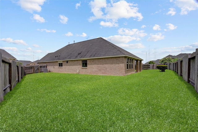 8426 Kari Bend Cir, Richmond, TX 77407 - back of property with brick siding, a fenced backyard, and roof with shingles