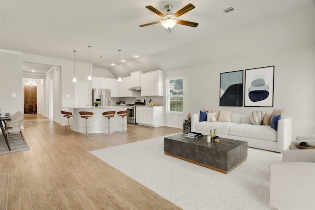 8426 Kari Bend Cir, Richmond, TX 77407 - living room with vaulted ceiling, ceiling fan, light wood-style flooring, and recessed lighting