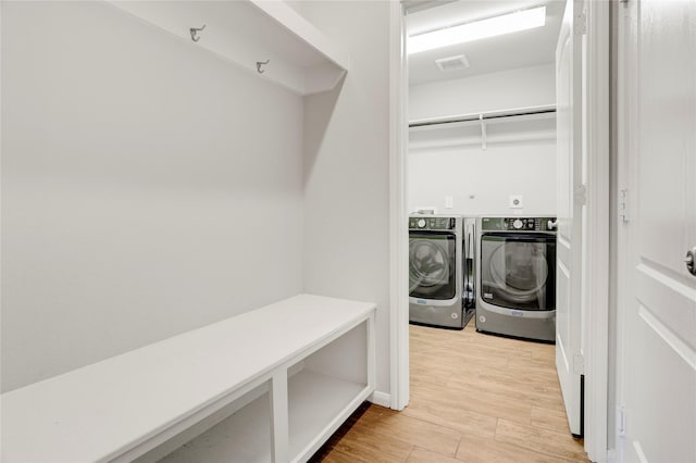 8426 Kari Bend Cir, Richmond, TX 77407 - washroom with washing machine and dryer and light wood finished floors