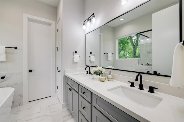846 Elkhart St Unit B, Houston, TX 77091 - full bathroom featuring marble look tile flooring, double vanity, a freestanding bath, a marble finish shower, and recessed lighting