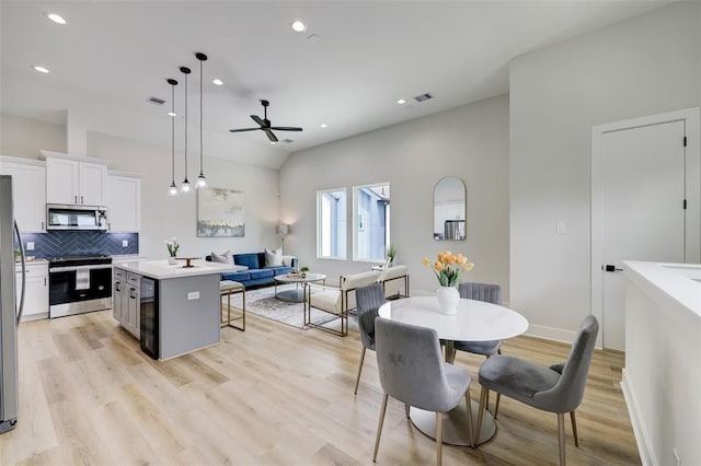 846 Elkhart St Unit B, Houston, TX 77091 - kitchen with appliances with stainless steel finishes, ceiling fan, white cabinets, tasteful backsplash, and a kitchen bar