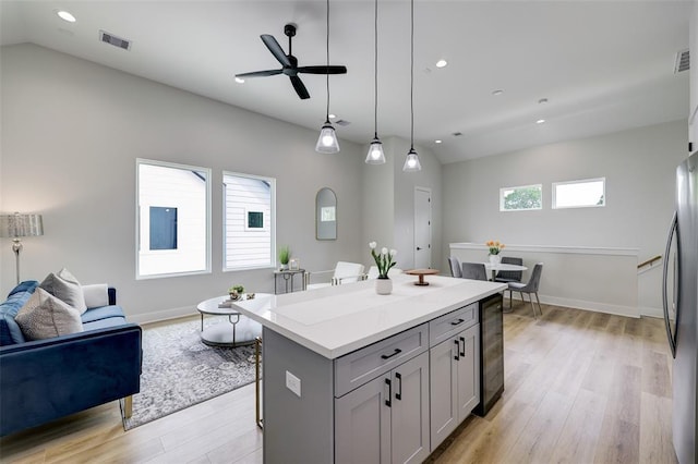 846 Elkhart St Unit B, Houston, TX 77091 - kitchen featuring beverage cooler, open floor plan, light wood-style floors, a ceiling fan, and a kitchen island