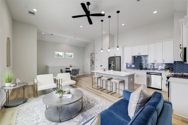 846 Elkhart St Unit B, Houston, TX 77091 - living room with light wood-style flooring, a ceiling fan, and recessed lighting