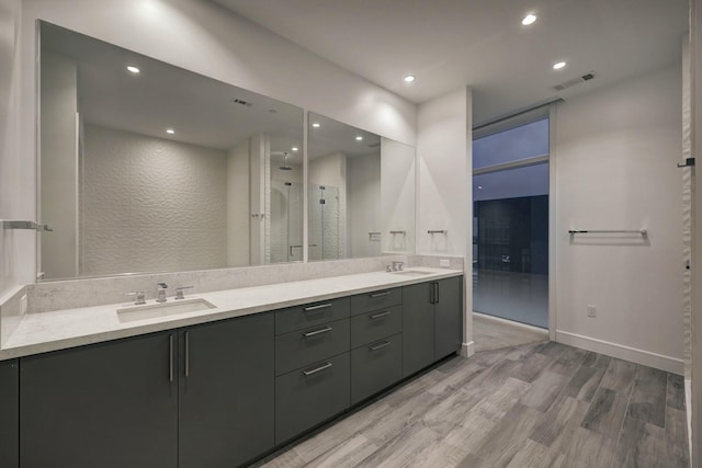4521 San Felipe St Unit 2304-5, Houston, TX 77027 - full bathroom with wood finished floors, double vanity, a shower stall, and recessed lighting