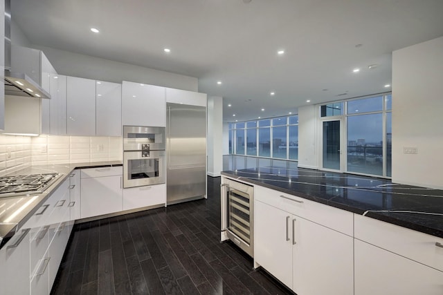 4521 San Felipe St Unit 2304-5, Houston, TX 77027 - kitchen featuring wine cooler, wall chimney exhaust hood, modern cabinets, appliances with stainless steel finishes, and dark wood-style flooring
