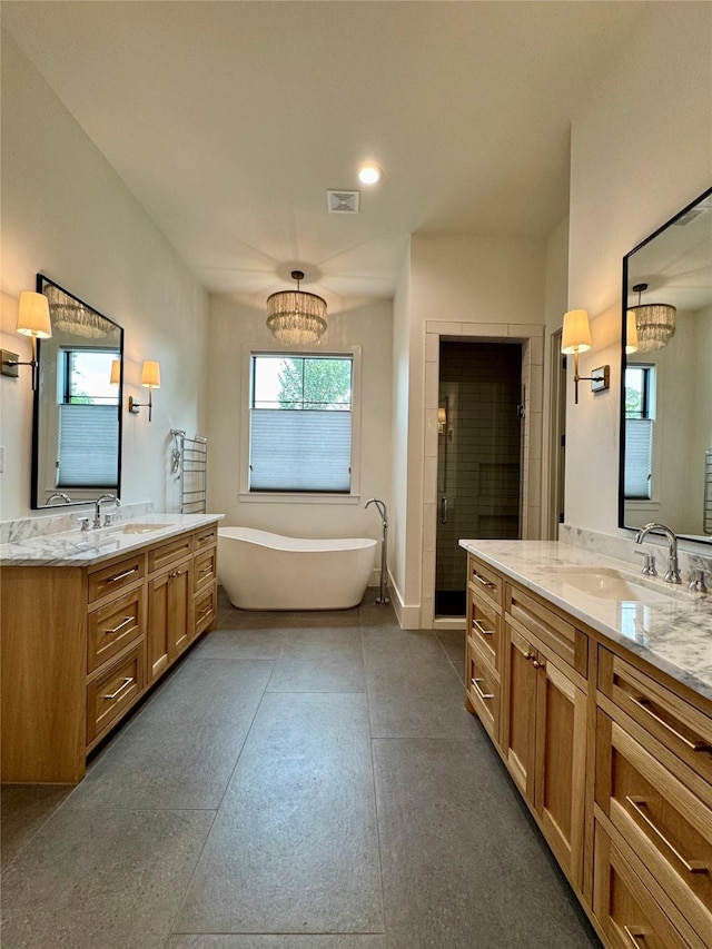 1701 Bayram Dr, Houston, TX 77055 - bathroom with a shower stall, two vanities, a freestanding bath, recessed lighting, and a chandelier