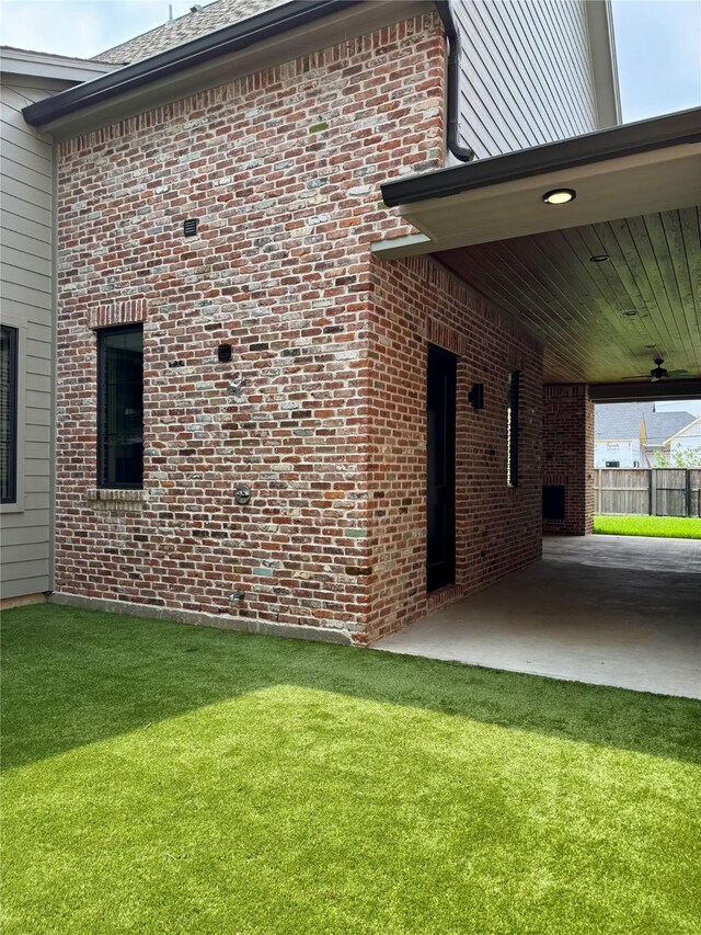 1701 Bayram Dr, Houston, TX 77055 - view of side of home featuring brick siding and a carport