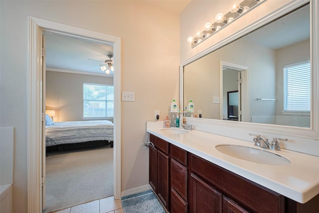 19914 Pemetic Trl, Richmond, TX 77407 - ensuite bathroom with double vanity, tile patterned floors, ceiling fan, and crown molding