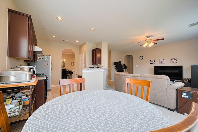 19914 Pemetic Trl, Richmond, TX 77407 - dining space featuring arched walkways, a ceiling fan, and recessed lighting