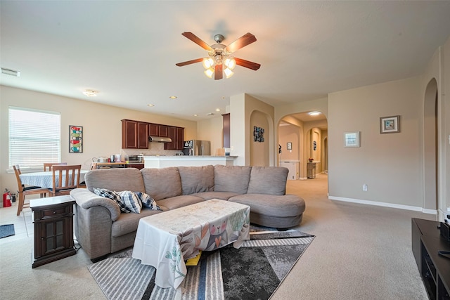 19914 Pemetic Trl, Richmond, TX 77407 - living room with arched walkways, light carpet, a ceiling fan, and recessed lighting