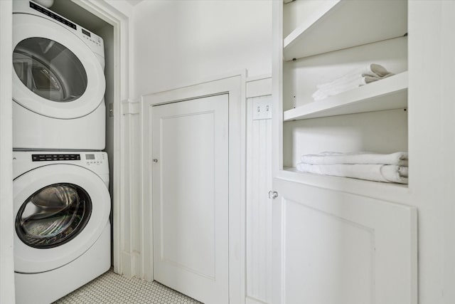 1656 Norfolk St, Houston, TX 77006 - washroom with stacked washer and clothes dryer and light tile patterned floors