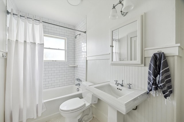 1656 Norfolk St, Houston, TX 77006 - full bathroom with shower / bath combo with shower curtain and a wainscoted wall