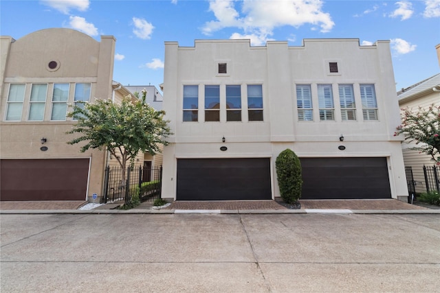 112 Riley Ln, Houston, TX 77003 - view of front facade featuring stucco siding, an attached garage, and driveway