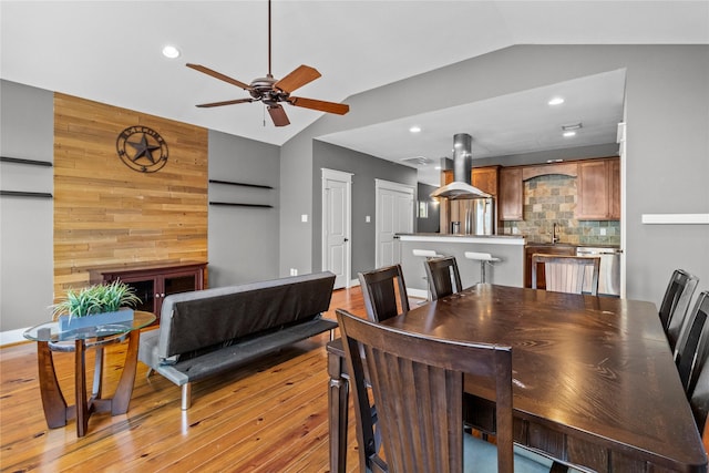 112 Riley Ln, Houston, TX 77003 - dining area featuring vaulted ceiling, a ceiling fan, light wood-type flooring, recessed lighting, and wooden walls