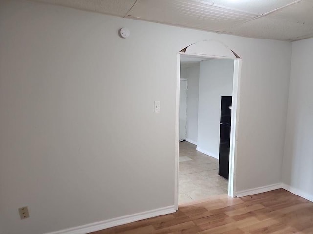 2705 Beatty St, Houston, TX 77023 - unfurnished room with arched walkways, a smoke detector, and light wood-style floors