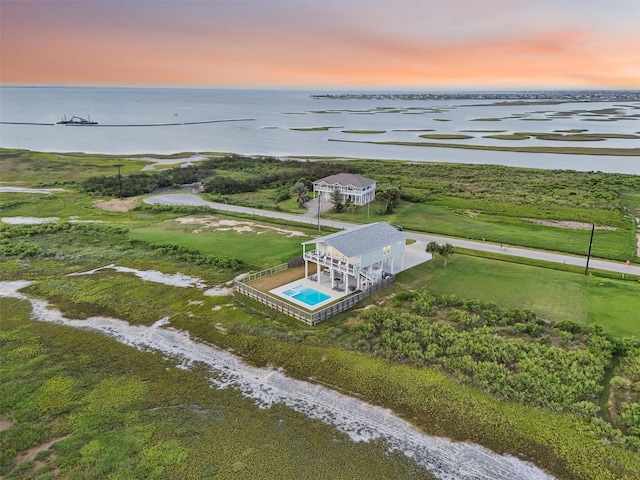 3430 Indian Beach Dr, Galveston, TX 77554 - aerial view at dusk of a water view and view of pool area