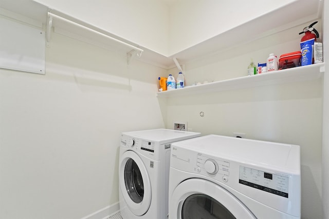 3430 Indian Beach Dr, Galveston, TX 77554 - laundry area with washer and clothes dryer and baseboards