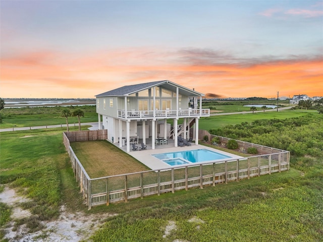 3430 Indian Beach Dr, Galveston, TX 77554 - back of house with a patio area, a fenced backyard, and a pool with connected hot tub