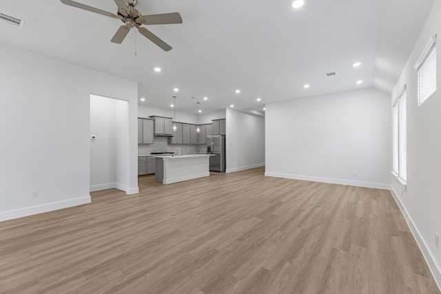 21410 Flora Springs Ln, Magnolia, TX 77355 - unfurnished living room featuring ceiling fan, recessed lighting, and light wood-style floors