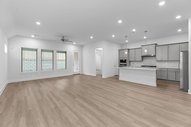 21410 Flora Springs Ln, Magnolia, TX 77355 - unfurnished living room with a ceiling fan, recessed lighting, and light wood-style floors