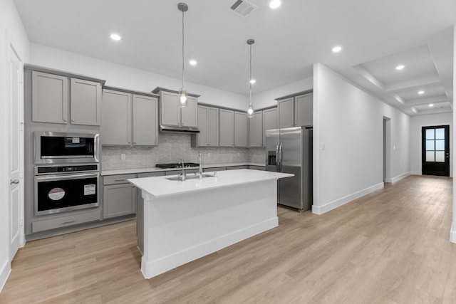 21410 Flora Springs Ln, Magnolia, TX 77355 - kitchen with stainless steel appliances, gray cabinets, light countertops, tasteful backsplash, and recessed lighting