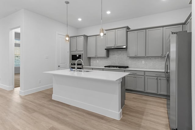21410 Flora Springs Ln, Magnolia, TX 77355 - kitchen with stainless steel appliances, gray cabinetry, decorative backsplash, and recessed lighting