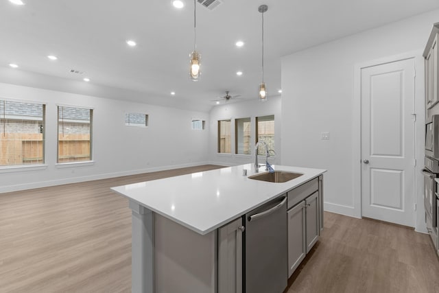 21410 Flora Springs Ln, Magnolia, TX 77355 - kitchen featuring appliances with stainless steel finishes, gray cabinets, light wood-style flooring, light countertops, and ceiling fan