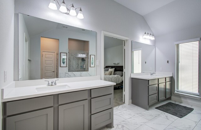 20207 Noble Arabian Dr, Tomball, TX 77377 - bathroom with lofted ceiling, ensuite bathroom, marble finish flooring, a walk in shower, and vanity