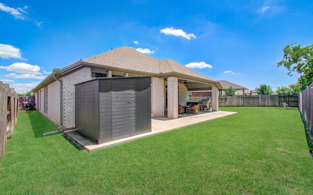 20207 Noble Arabian Dr, Tomball, TX 77377 - back of property featuring brick siding, a fenced backyard, ceiling fan, a patio area, and a shingled roof
