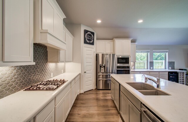 20207 Noble Arabian Dr, Tomball, TX 77377 - kitchen featuring stainless steel appliances, light countertops, white cabinetry, recessed lighting, and dark wood-type flooring