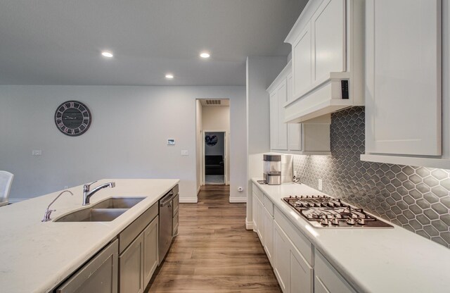 20207 Noble Arabian Dr, Tomball, TX 77377 - kitchen with light wood-type flooring, light countertops, recessed lighting, tasteful backsplash, and white cabinetry