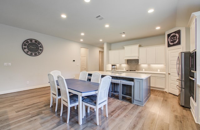 20207 Noble Arabian Dr, Tomball, TX 77377 - dining room with light wood finished floors and recessed lighting