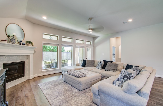 20207 Noble Arabian Dr, Tomball, TX 77377 - living room with ceiling fan, wood finished floors, a stone fireplace, and recessed lighting