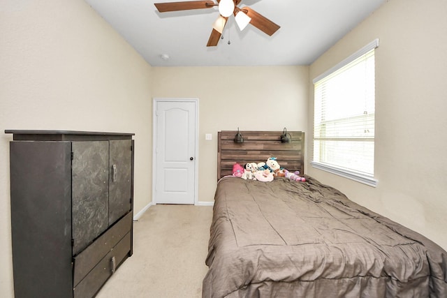6810 Hunters Trace Ln, Baytown, TX 77521 - bedroom with light colored carpet and a ceiling fan