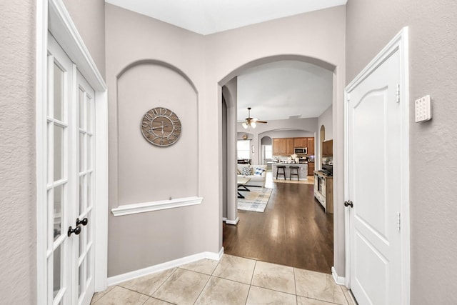 6810 Hunters Trace Ln, Baytown, TX 77521 - hall with arched walkways and light tile patterned floors