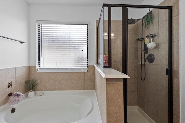 13206 Blass Ct, Houston, TX 77044 - bathroom with a bath, a stall shower, and healthy amount of natural light