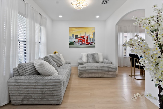 13206 Blass Ct, Houston, TX 77044 - sitting room with arched walkways, wood finished floors, and recessed lighting