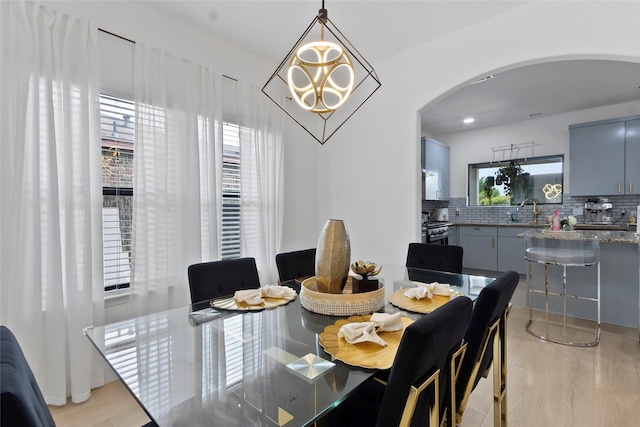 13206 Blass Ct, Houston, TX 77044 - dining area featuring arched walkways and a chandelier