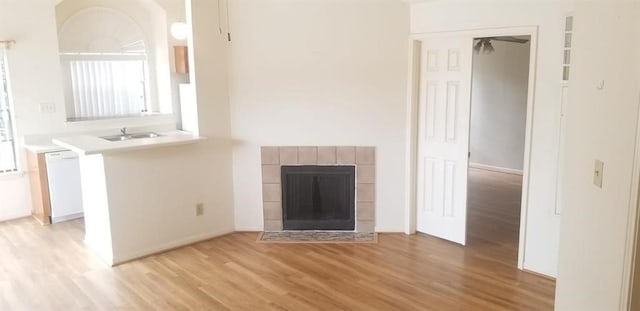 2300 Old Spanish Trl Unit 2116, Houston, TX 77054 - unfurnished living room featuring light wood-style floors and a fireplace