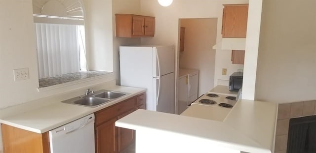 2300 Old Spanish Trl Unit 2116, Houston, TX 77054 - kitchen featuring white appliances, extractor fan, light countertops, a peninsula, and brown cabinets