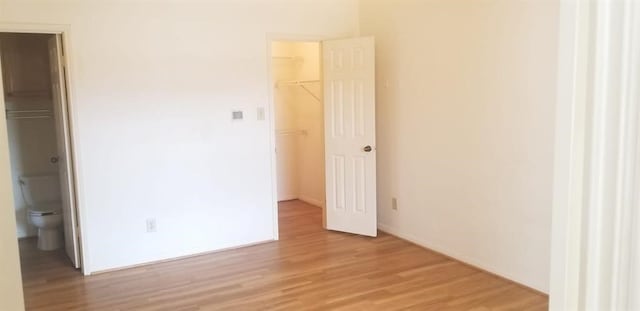 2300 Old Spanish Trl Unit 2116, Houston, TX 77054 - unfurnished bedroom with a spacious closet, light wood-style floors, and a closet