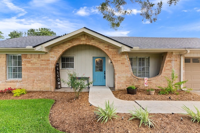 2605 Perry Ln, Alvin, TX 77511 - view of front of property featuring roof with shingles, brick siding, a garage, and board and batten siding