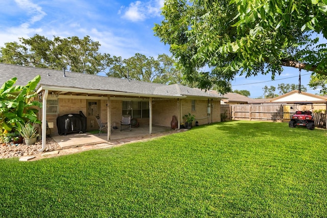2605 Perry Ln, Alvin, TX 77511 - rear view of house with brick siding, roof with shingles, a patio, and a fenced backyard