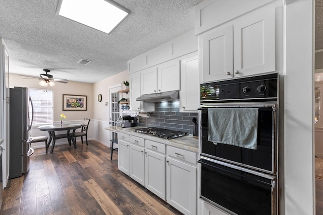 2605 Perry Ln, Alvin, TX 77511 - kitchen with appliances with stainless steel finishes, white cabinets, a textured ceiling, light countertops, and dark wood-style floors