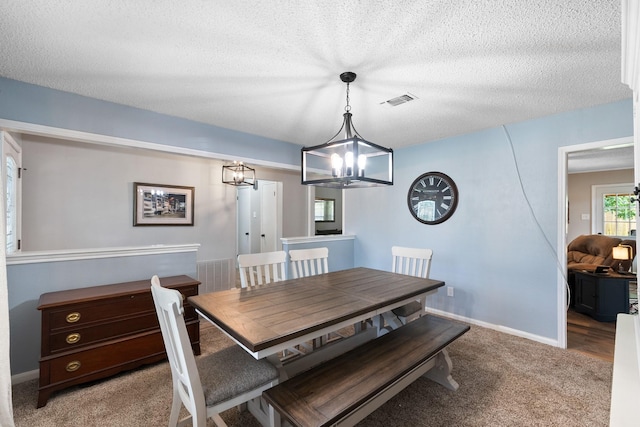 2605 Perry Ln, Alvin, TX 77511 - dining room featuring a chandelier, light carpet, and a textured ceiling